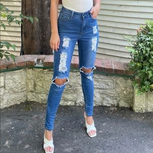 Medium blue wash high rise distressed jean